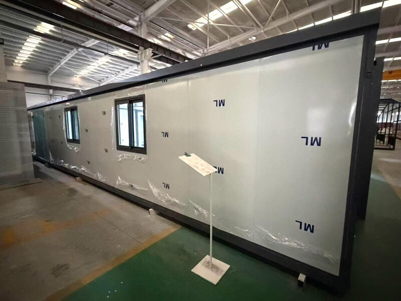Unfinished flat pack container house stored in factory warehouse